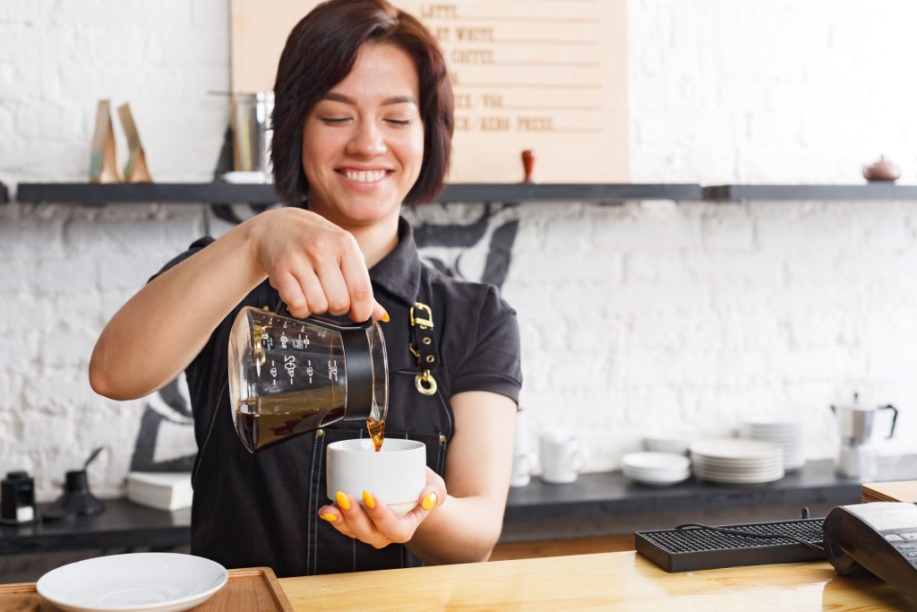 Young disability barista working at cafe