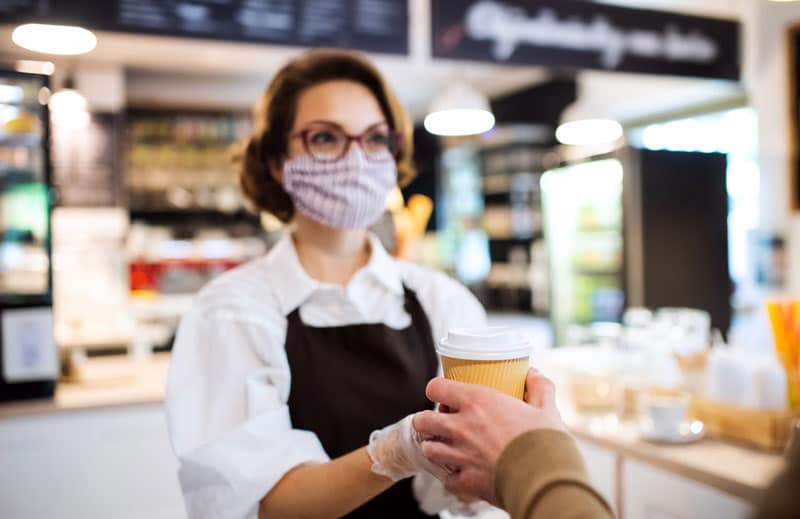 Young woman with face mask working indoors